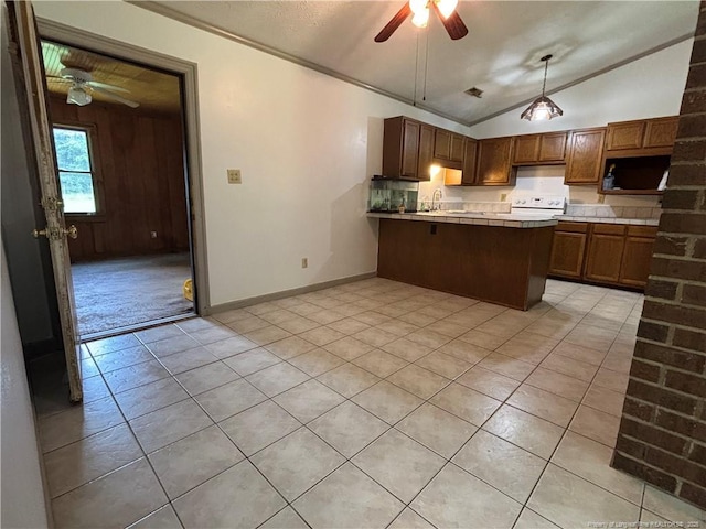 5200 Pineview Rd, Lumberton, NC 28360 - kitchen with a ceiling fan, white electric range oven, a peninsula, vaulted ceiling, and light tile patterned flooring