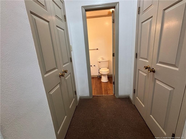 5200 Pineview Rd, Lumberton, NC 28360 - hall with dark colored carpet, dark wood-type flooring, and a textured wall