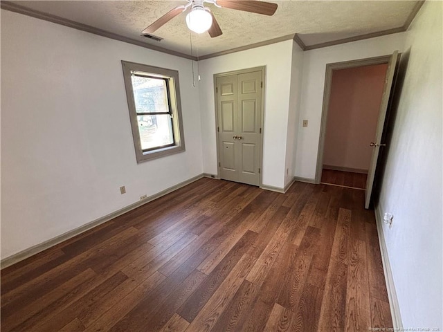 5200 Pineview Rd, Lumberton, NC 28360 - unfurnished bedroom featuring dark wood-type flooring, a textured ceiling, crown molding, and ceiling fan