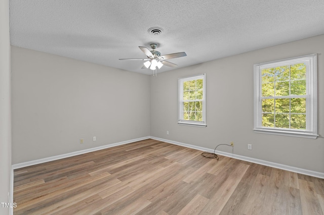113 Fox Run, Henderson, NC 27536 - spare room featuring light wood-style floors, ceiling fan, and a textured ceiling