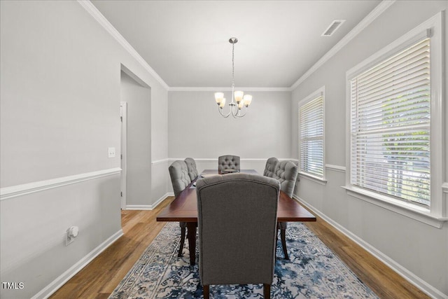 601 Richlands Cliff Dr, Youngsville, NC 27596 - dining room with wood finished floors, a chandelier, and crown molding