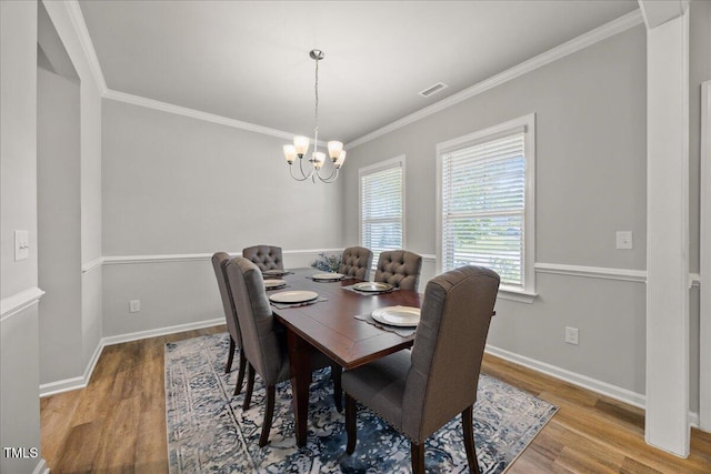 601 Richlands Cliff Dr, Youngsville, NC 27596 - dining room featuring wood finished floors, a chandelier, and ornamental molding