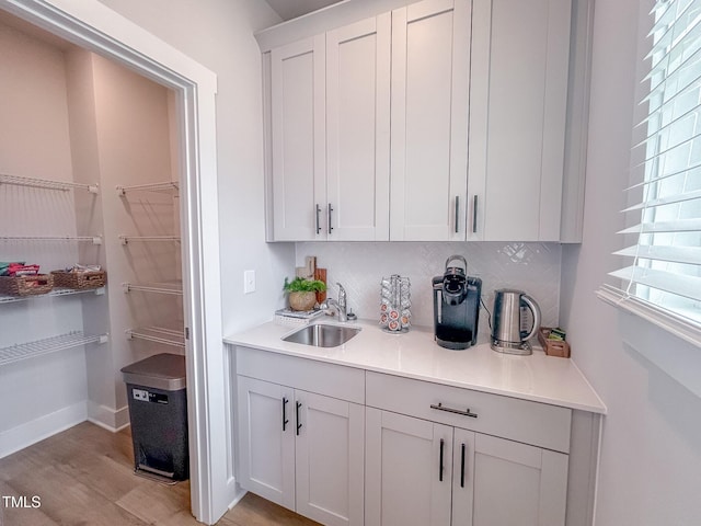 124 Sugar Run Dr Unit 11, Fuquay Varina, NC 27526 - kitchen featuring backsplash, light wood finished floors, light countertops, and white cabinetry