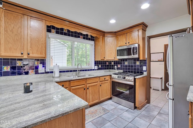 6701 Winding Trl, Raleigh, NC 27612 - kitchen with stainless steel appliances, tasteful backsplash, light stone countertops, light tile patterned floors, and recessed lighting
