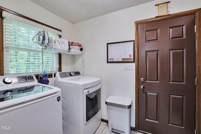 6701 Winding Trl, Raleigh, NC 27612 - laundry area with washing machine and dryer and light tile patterned floors
