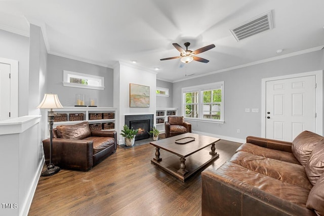 1920 Hart St, Durham, NC 27703 - living area featuring ornamental molding, a ceiling fan, wood finished floors, and a fireplace with flush hearth
