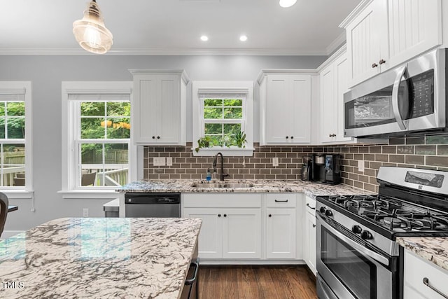 1920 Hart St, Durham, NC 27703 - kitchen with appliances with stainless steel finishes, healthy amount of natural light, white cabinetry, crown molding, and recessed lighting