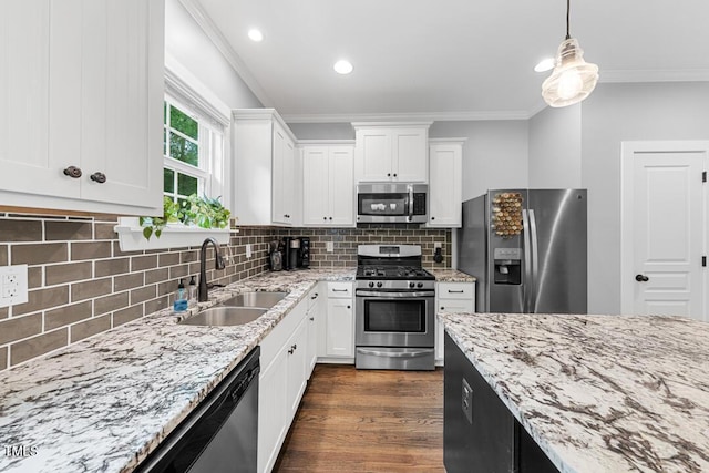 1920 Hart St, Durham, NC 27703 - kitchen featuring appliances with stainless steel finishes, ornamental molding, white cabinets, dark wood-style floors, and light stone countertops