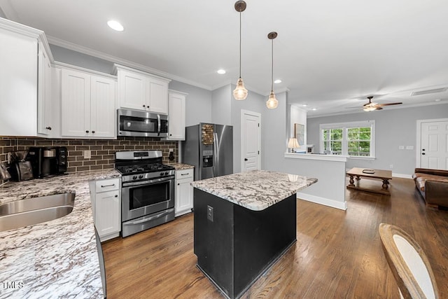 1920 Hart St, Durham, NC 27703 - kitchen featuring appliances with stainless steel finishes, backsplash, crown molding, open floor plan, and dark wood-type flooring