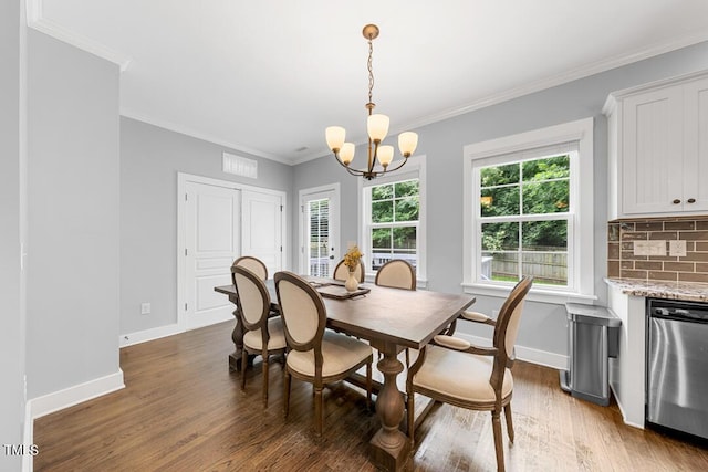 1920 Hart St, Durham, NC 27703 - dining room with wood finished floors, a chandelier, and crown molding