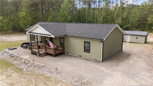 588 Heritage Farm Rd, Carthage, NC 28327 - view of front of home with crawl space, a forest view, a shingled roof, an outbuilding, and driveway