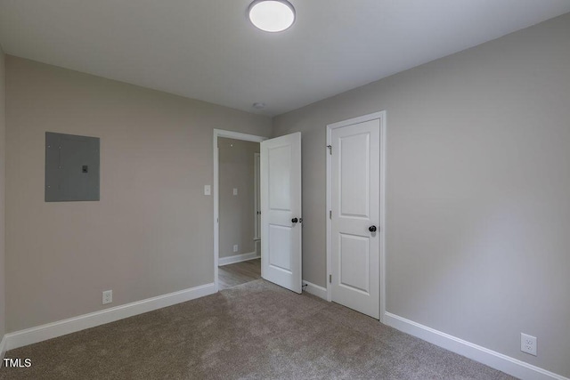 1708 Forest Rd, Durham, NC 27705 - unfurnished bedroom featuring electric panel and carpet