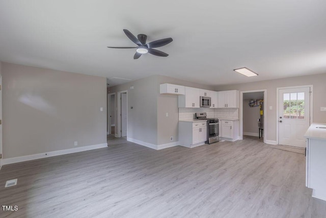 1708 Forest Rd, Durham, NC 27705 - kitchen with stainless steel appliances, light countertops, white cabinets, a ceiling fan, and light wood-style flooring