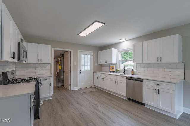 1708 Forest Rd, Durham, NC 27705 - kitchen with appliances with stainless steel finishes, light countertops, and light wood-type flooring