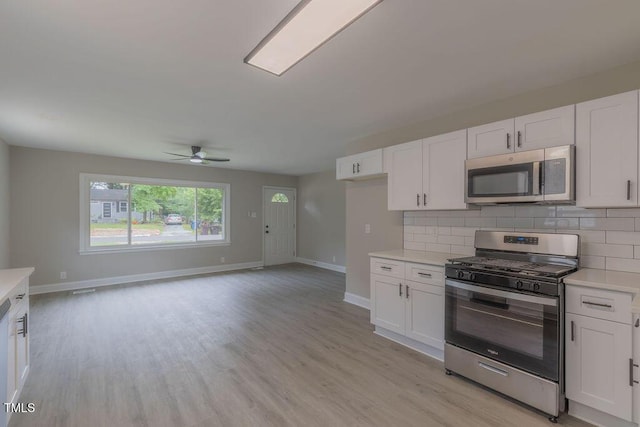 1708 Forest Rd, Durham, NC 27705 - kitchen featuring appliances with stainless steel finishes, light countertops, ceiling fan, and white cabinetry