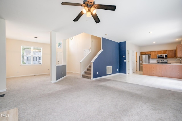 2241 Spruce Shadows Ln, Raleigh, NC 27614 - unfurnished living room featuring light carpet, stairway, a ceiling fan, and recessed lighting