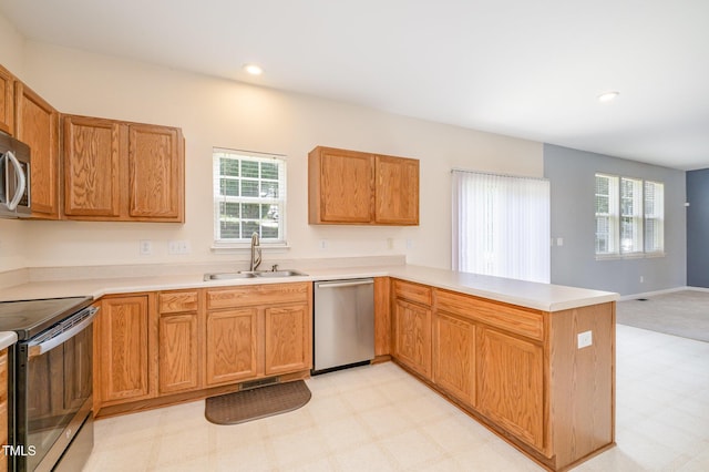 2241 Spruce Shadows Ln, Raleigh, NC 27614 - kitchen featuring stainless steel appliances, light floors, a peninsula, light countertops, and recessed lighting