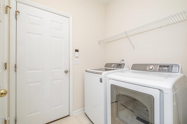 2241 Spruce Shadows Ln, Raleigh, NC 27614 - laundry room with washing machine and clothes dryer and baseboards