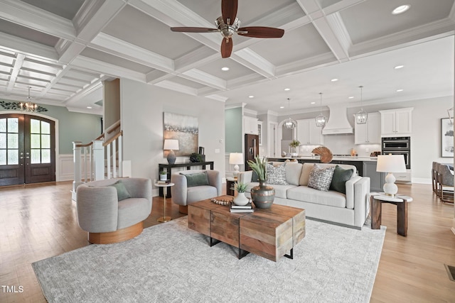 121 Hardy Oaks Way, Holly Springs, NC 27540 - living area with light wood finished floors, coffered ceiling, ceiling fan, stairs, and beamed ceiling