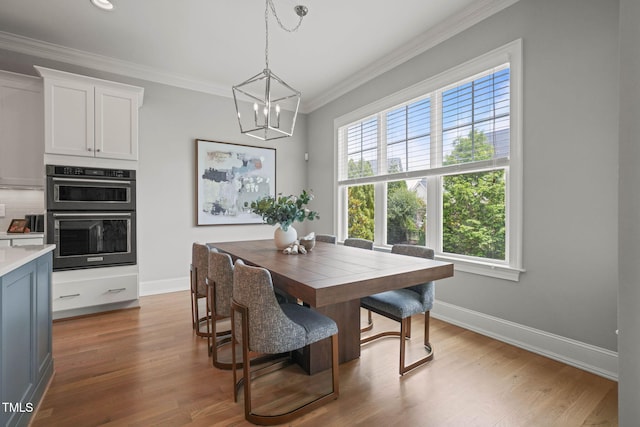 121 Hardy Oaks Way, Holly Springs, NC 27540 - dining space with plenty of natural light, a chandelier, ornamental molding, and wood finished floors