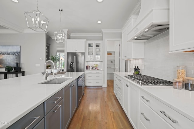 121 Hardy Oaks Way, Holly Springs, NC 27540 - kitchen with premium range hood, stainless steel appliances, ornamental molding, white cabinets, and light countertops