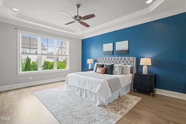 121 Hardy Oaks Way, Holly Springs, NC 27540 - bedroom with a tray ceiling, wood finished floors, ornamental molding, ceiling fan, and recessed lighting