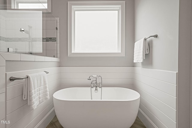 121 Hardy Oaks Way, Holly Springs, NC 27540 - bathroom with a soaking tub and a wainscoted wall