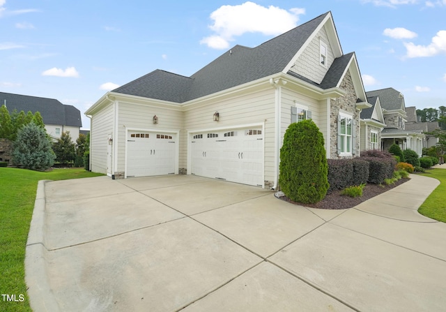 121 Hardy Oaks Way, Holly Springs, NC 27540 - view of side of property featuring concrete driveway, an attached garage, stone siding, a yard, and roof with shingles