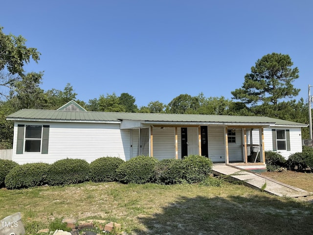269 Beagle Run Ln, Aberdeen, NC 28315 - single story home featuring covered porch, a metal roof, and a front lawn