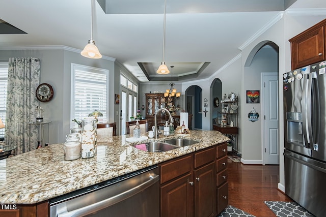 514 Ashley Woods Dr, Gibsonville, NC 27249 - kitchen featuring appliances with stainless steel finishes, arched walkways, a raised ceiling, dark wood-style flooring, and crown molding