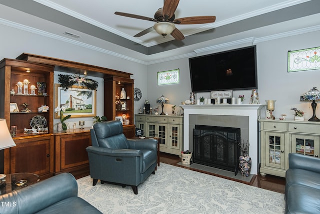 514 Ashley Woods Dr, Gibsonville, NC 27249 - living room featuring wood finished floors, ceiling fan, a tile fireplace, and ornamental molding