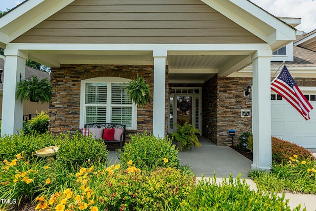 514 Ashley Woods Dr, Gibsonville, NC 27249 - entrance to property featuring stone siding, a porch, and an attached garage