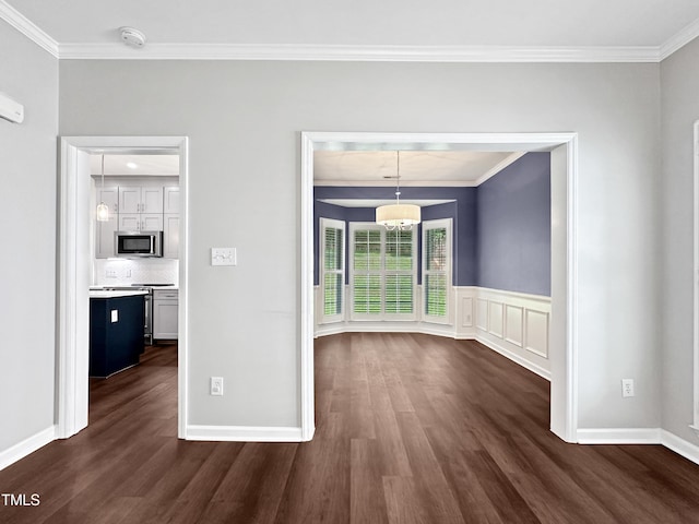 8640 Swarthmore Dr, Raleigh, NC 27615 - unfurnished dining area with ornamental molding, dark wood-style floors, and a wainscoted wall