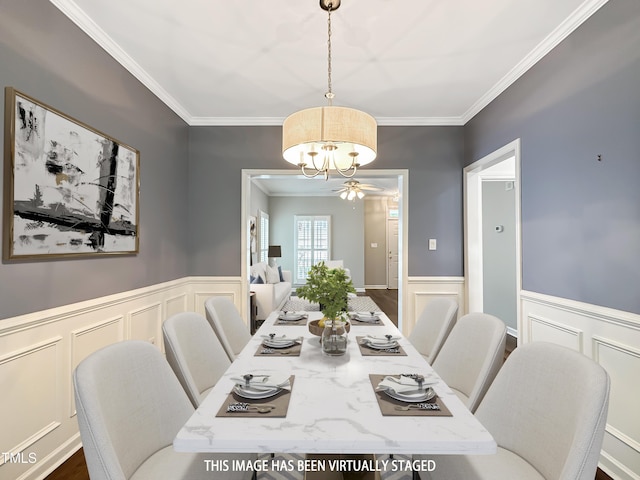 8640 Swarthmore Dr, Raleigh, NC 27615 - dining area featuring a decorative wall, crown molding, a chandelier, and wainscoting