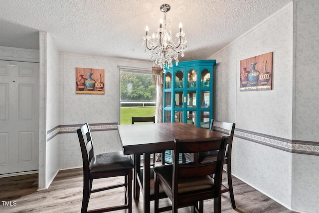 558 Christys Way, Roxboro, NC 27574 - dining space with a textured ceiling, wood finished floors, ornamental molding, and a chandelier