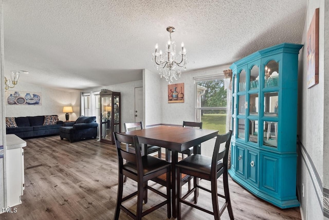 558 Christys Way, Roxboro, NC 27574 - dining area with a textured ceiling, a chandelier, and wood finished floors