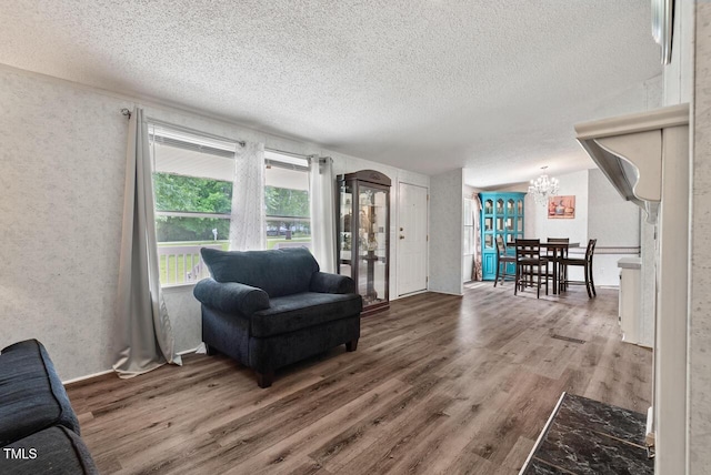 558 Christys Way, Roxboro, NC 27574 - sitting room with wood finished floors, a textured ceiling, and a chandelier