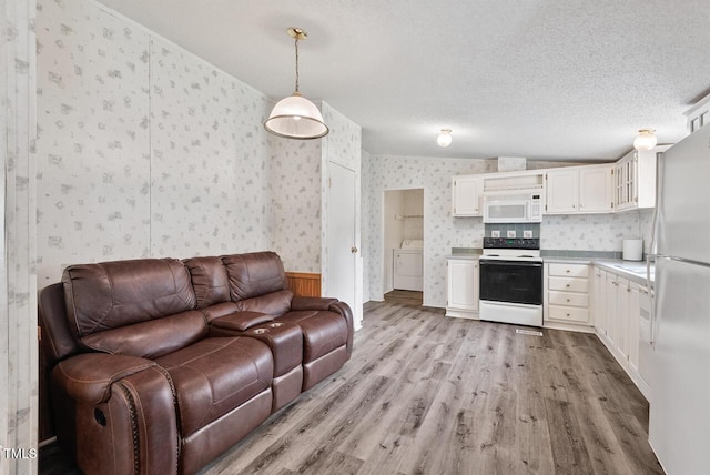 558 Christys Way, Roxboro, NC 27574 - living room with wallpapered walls, washer / clothes dryer, light wood-type flooring, and a textured ceiling