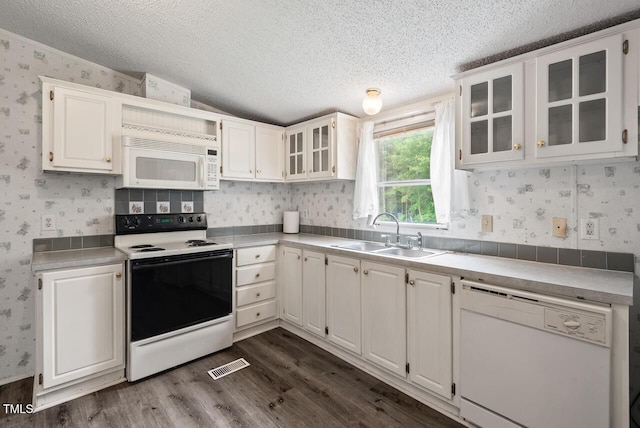 558 Christys Way, Roxboro, NC 27574 - kitchen featuring white appliances, wallpapered walls, a textured ceiling, dark wood-style flooring, and white cabinetry