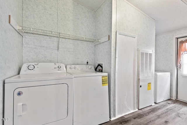 558 Christys Way, Roxboro, NC 27574 - laundry area featuring washer and clothes dryer, a heating unit, and light wood-style flooring
