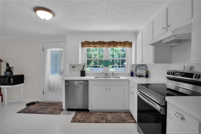 92 Nathan Dudley Rd, Clinton, NC 28328 - kitchen featuring appliances with stainless steel finishes, under cabinet range hood, a textured ceiling, light countertops, and white cabinets