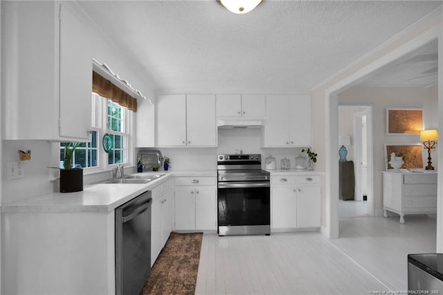 92 Nathan Dudley Rd, Clinton, NC 28328 - kitchen featuring appliances with stainless steel finishes, under cabinet range hood, white cabinets, a textured ceiling, and light countertops