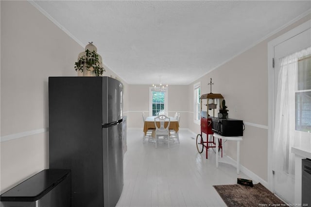 92 Nathan Dudley Rd, Clinton, NC 28328 - kitchen with freestanding refrigerator, light wood-style flooring, a chandelier, and ornamental molding