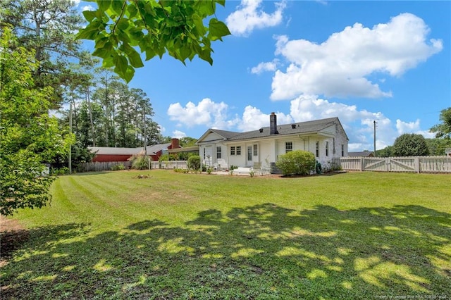 92 Nathan Dudley Rd, Clinton, NC 28328 - rear view of property featuring a fenced backyard and a chimney