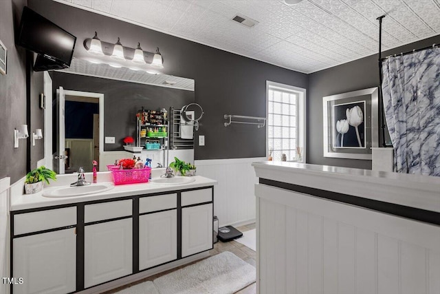 6001 Winged Willet Ct, Wendell, NC 27591 - full bathroom with double vanity and wainscoting