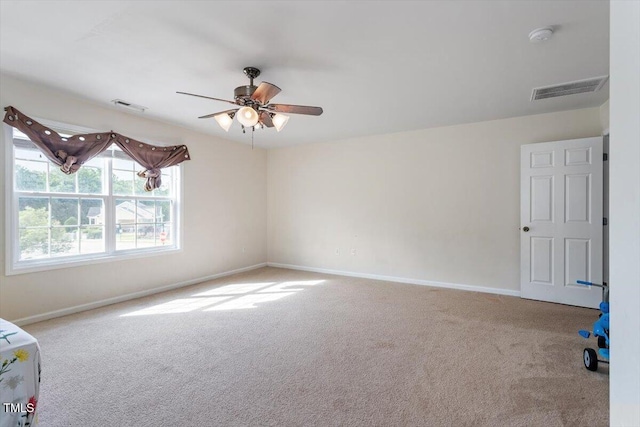 6001 Winged Willet Ct, Wendell, NC 27591 - spare room featuring carpet, a ceiling fan, and a smoke detector