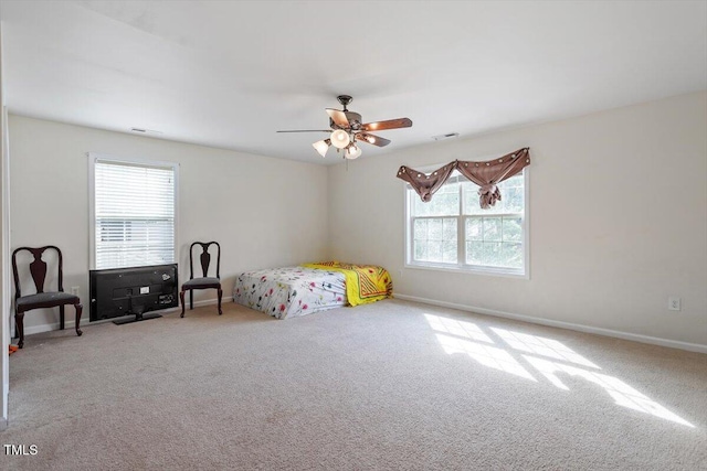 6001 Winged Willet Ct, Wendell, NC 27591 - carpeted bedroom with multiple windows and a ceiling fan