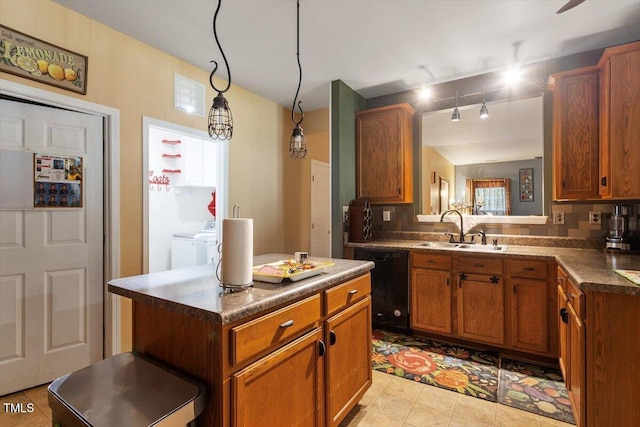 6001 Winged Willet Ct, Wendell, NC 27591 - kitchen with dishwasher, washing machine and dryer, a kitchen island, brown cabinets, and dark countertops