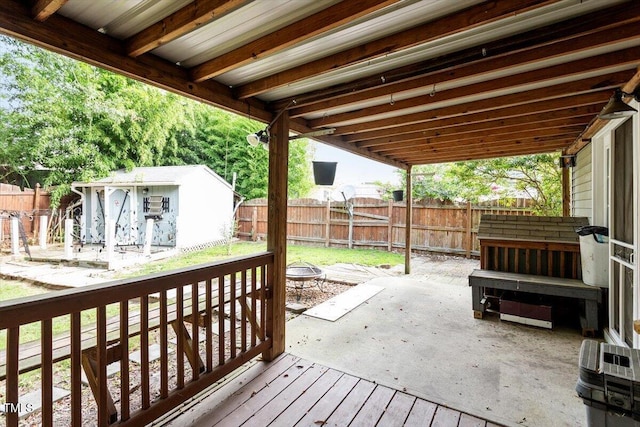 6001 Winged Willet Ct, Wendell, NC 27591 - wooden terrace with an outdoor fire pit, a fenced backyard, a patio, and a storage unit