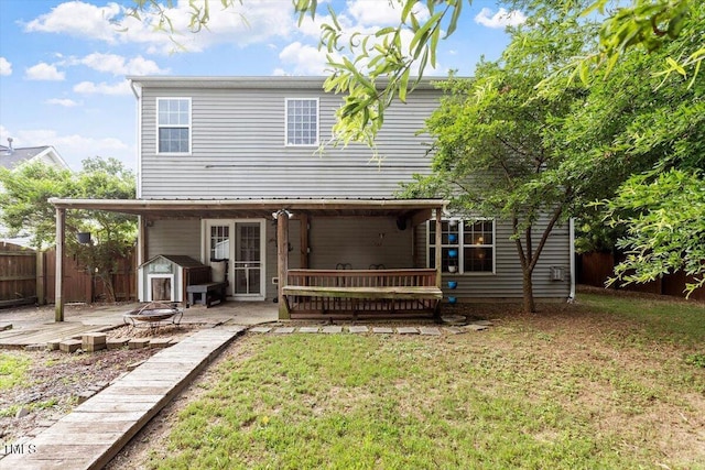 6001 Winged Willet Ct, Wendell, NC 27591 - rear view of property with a fire pit, a wooden deck, and a storage unit